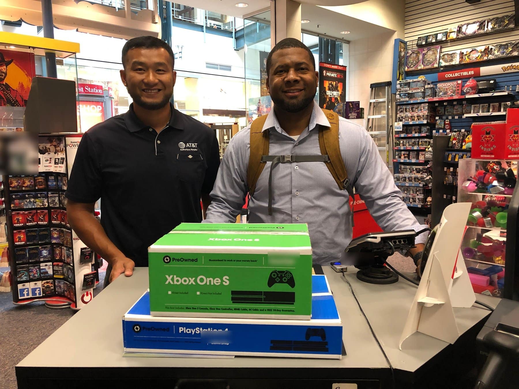 Gavin Brooks at a retail counter with a colleague