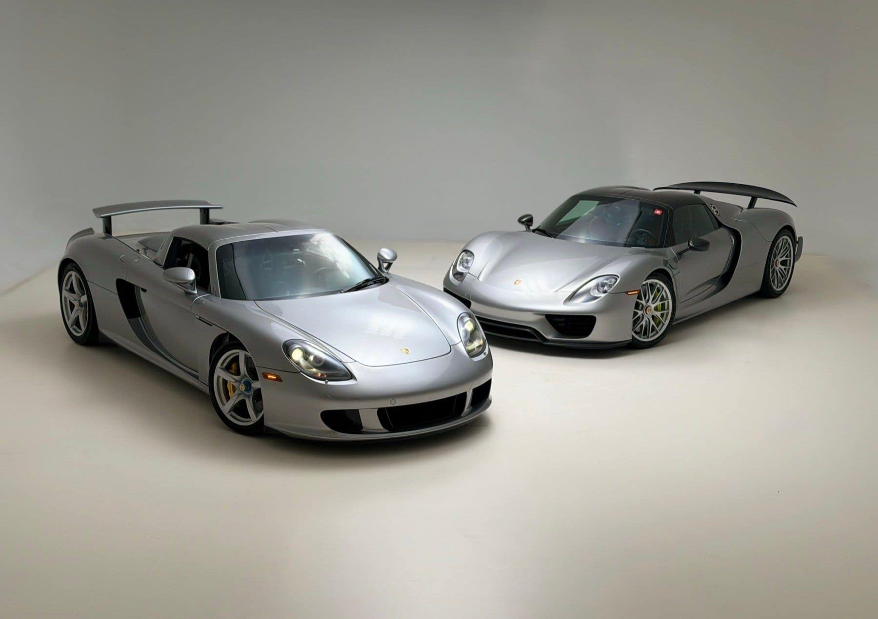 A Porsche Carrera GT and a Porsche 918 Spyder in a studio, sourced through the PaddockGavin network