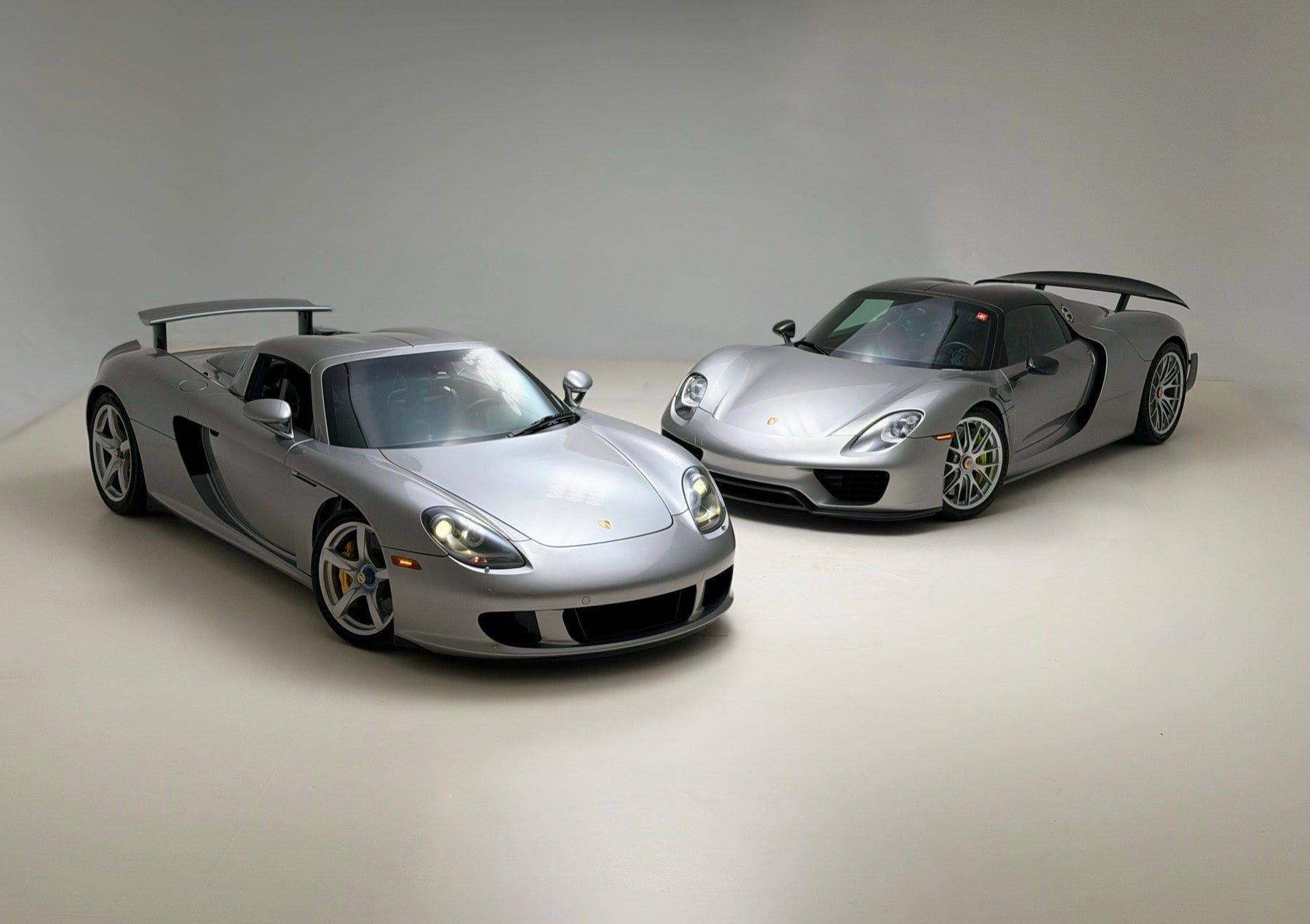 A Porsche Carrera GT and a Porsche 918 Spyder in a studio, sourced through the PaddockGavin network