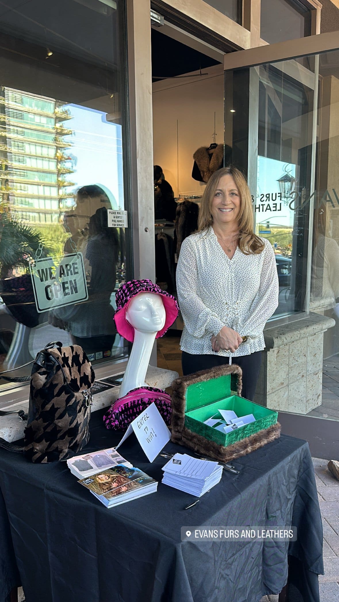 A vendor table for Evans Furs and Leathers outside the storefront