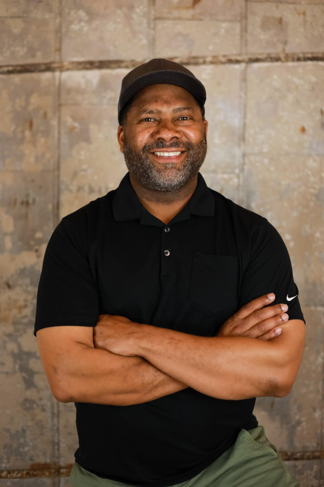 Portrait of Gavin Brooks, arms crossed, smiling at the camera