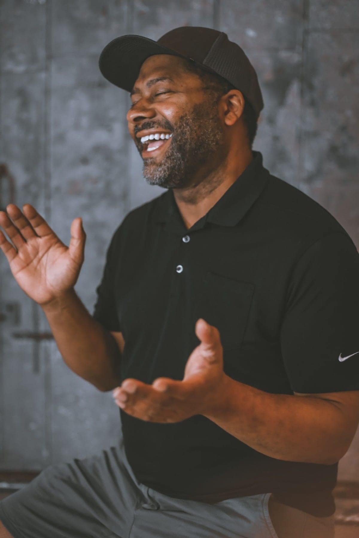 Gavin Brooks laughing mid-conversation, hands open
